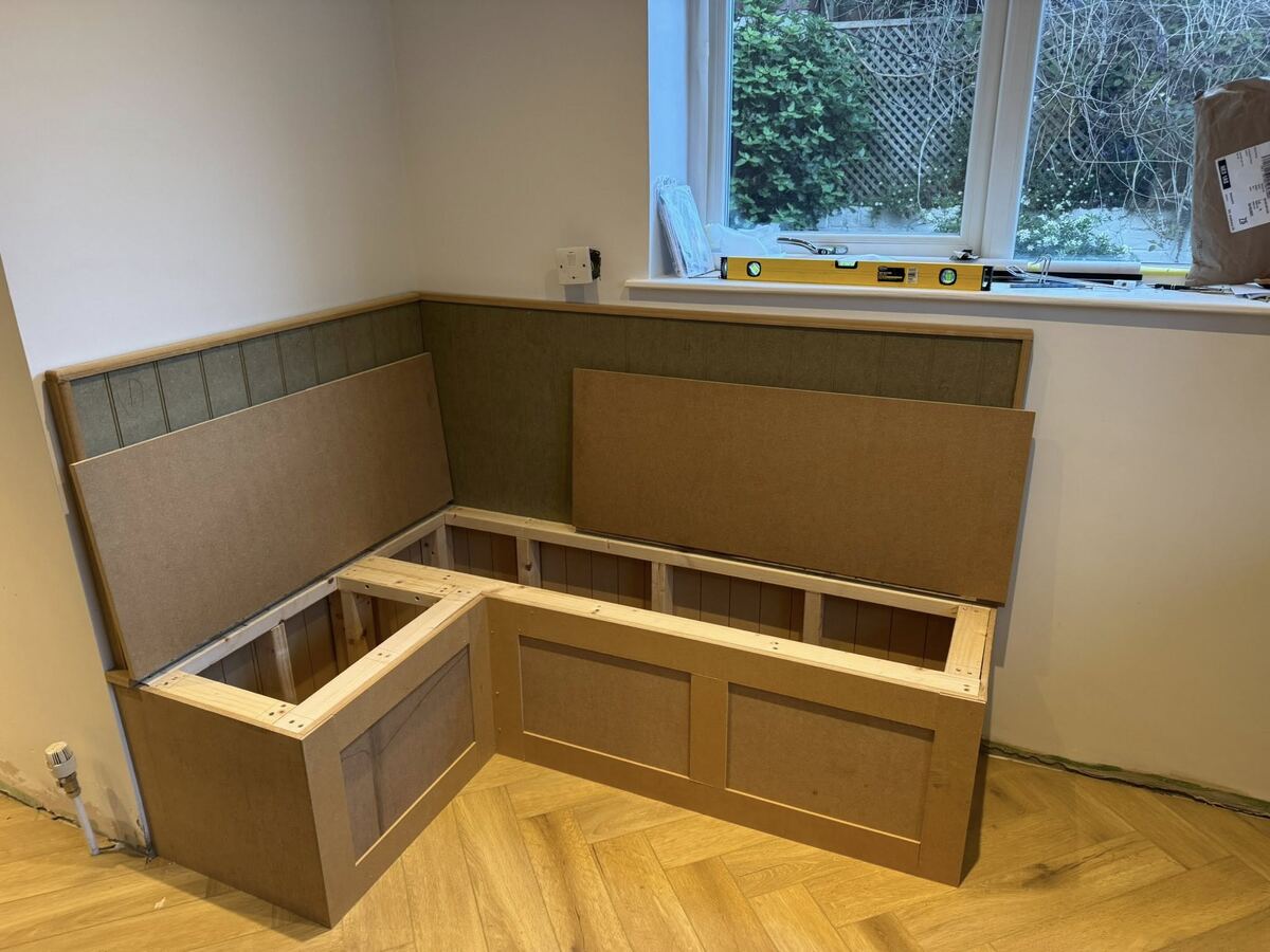 Bespoke L-shaped bench seat with lift-up storage being built under a window